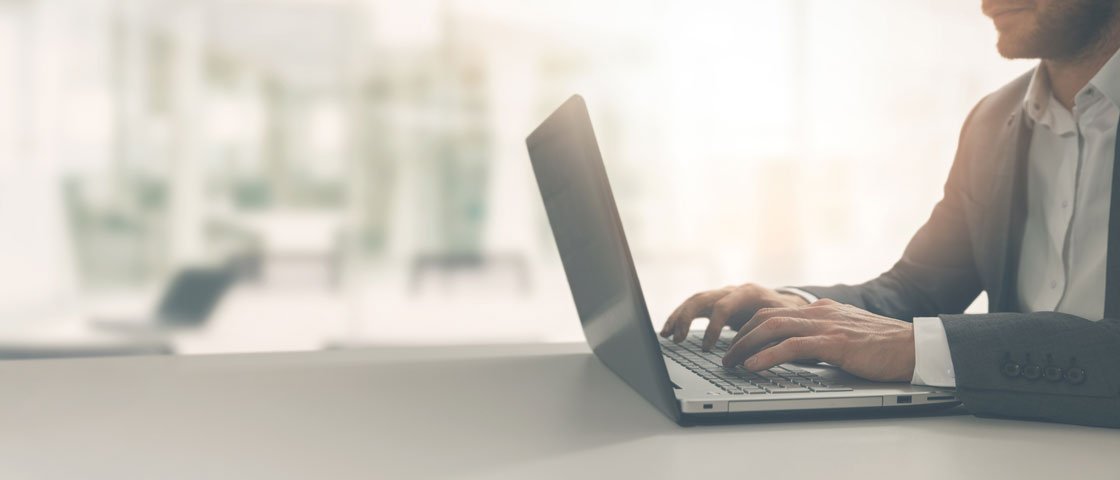 Man typing on a laptop