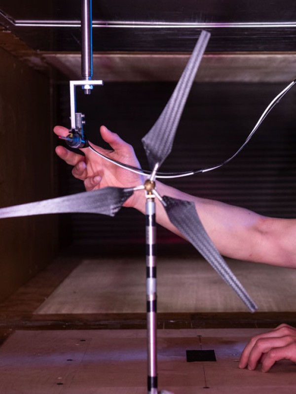Student placing equipment into wind tunnel to test