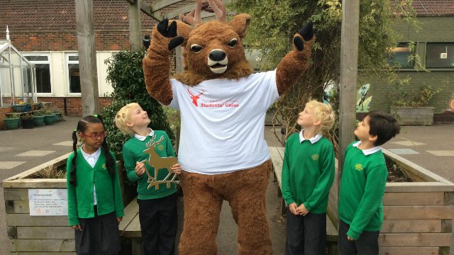 School pupils with the Surrey stag