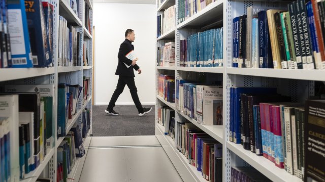 Student walking through the library