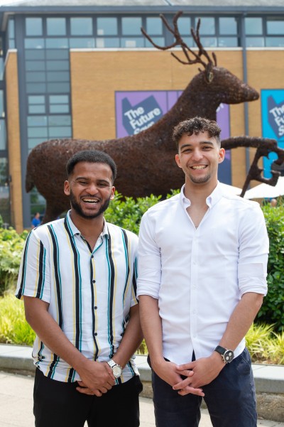 Photo of the Battersea Scholars, Luke and Anwar in front of a Stag