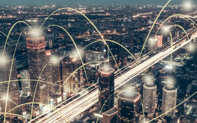 City at night with communication dots connecting different buildings