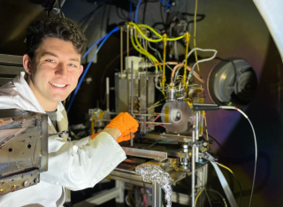 A photo of Dr Mansur Tisaev inside the Plasma Propulsion Lab at the University of Surrey. 