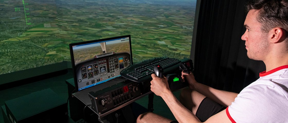 Student using flying simulator equipment