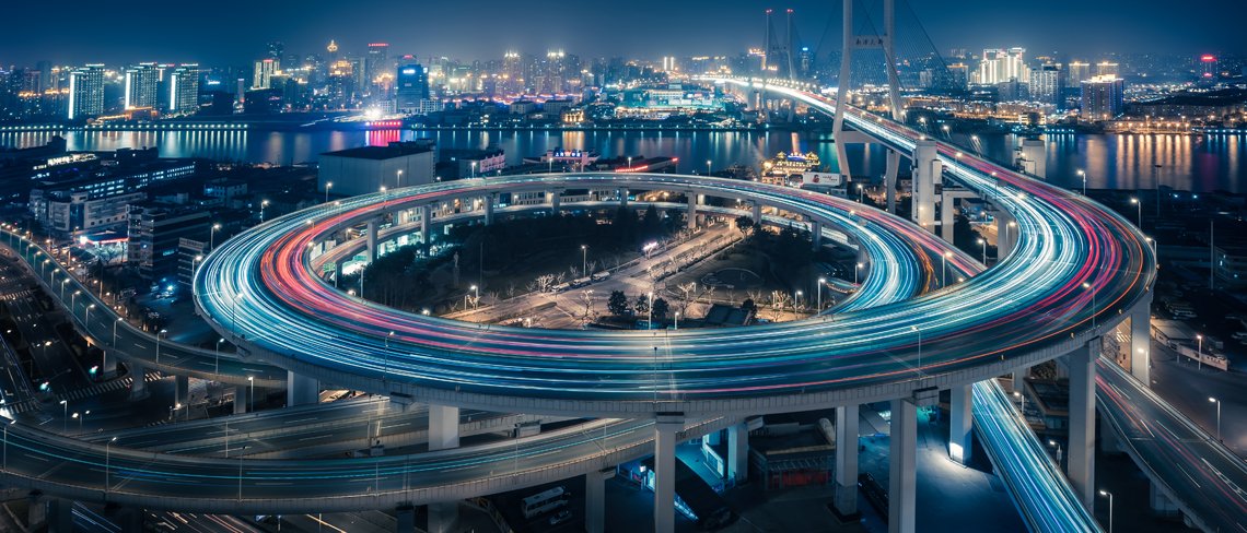 A view of urban traffic flowing through a city at night
