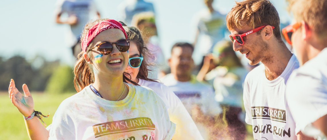 University of Surrey students on a colour run throwing paint powder