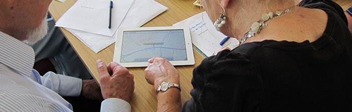 Two elderly people using a tablet