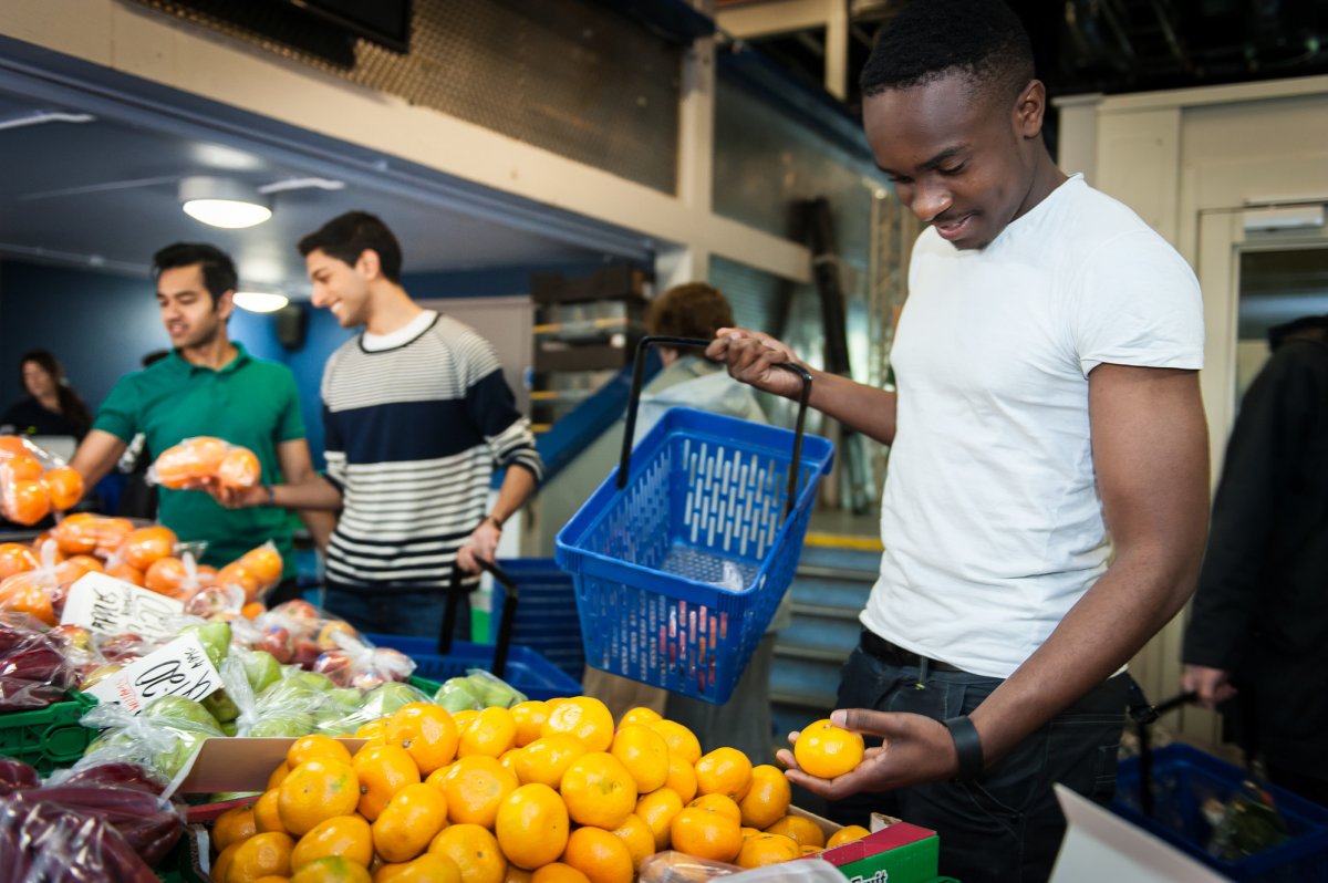 Students buying vegetables at the University of Surrey Fruit and Veg Market