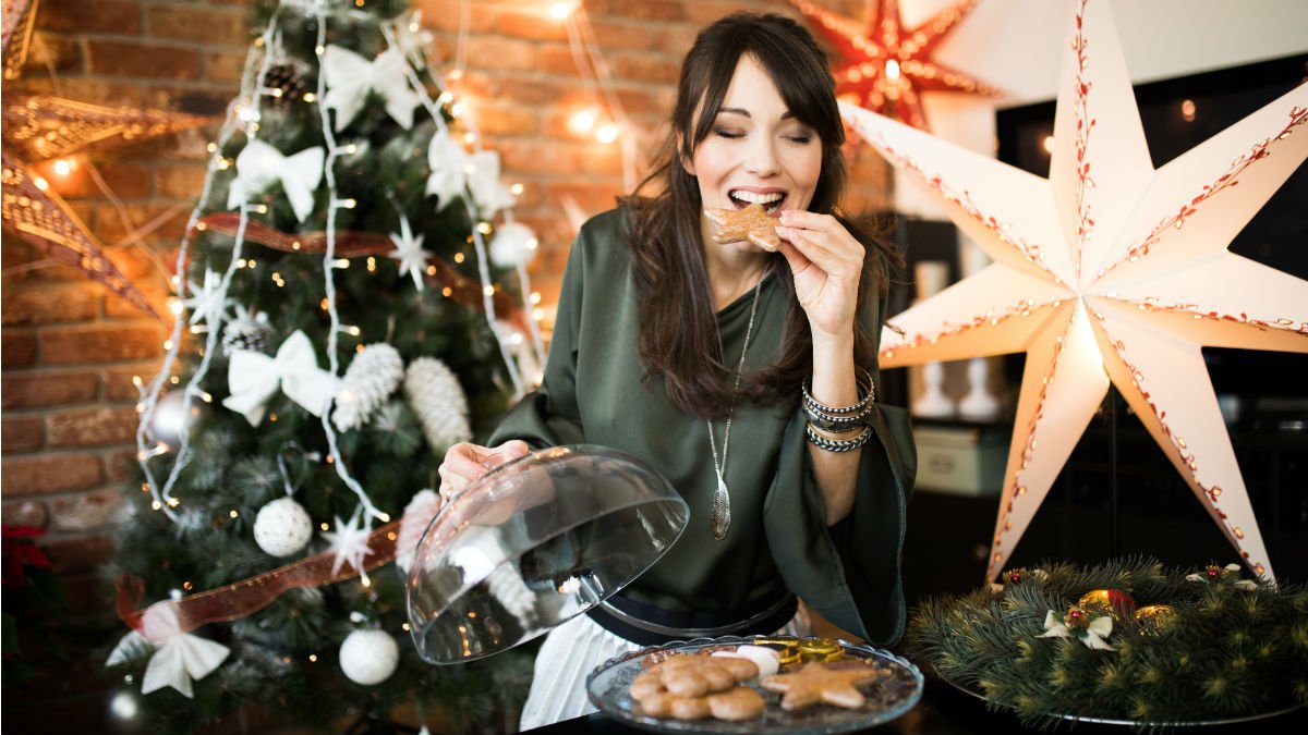Woman eating a Christmas cookie