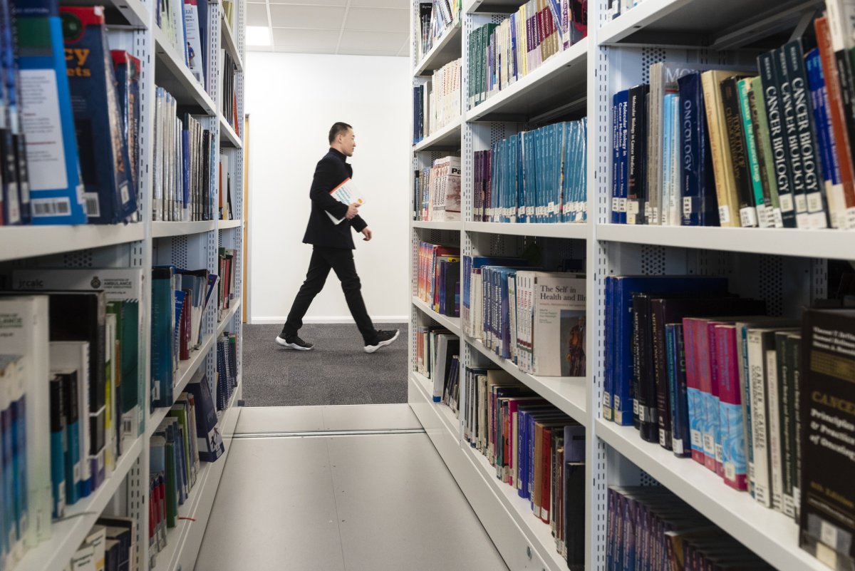 Student walking through the library