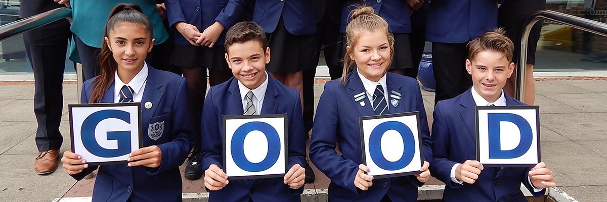 Kings College Guildford school students holding up letters to spell 'good'