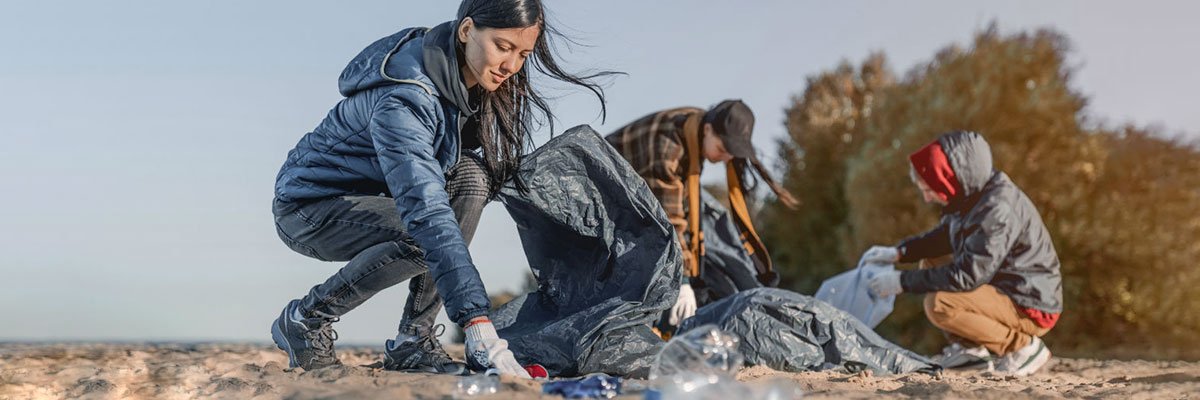 People litter picking on a beach