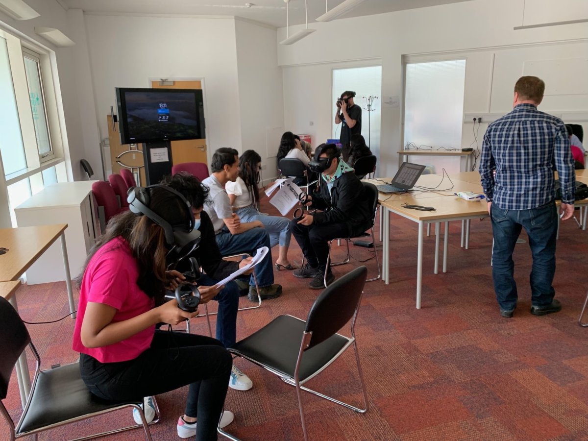 Management MSc student Dom Wong with fellow postgrads trying out virtual reality equipment