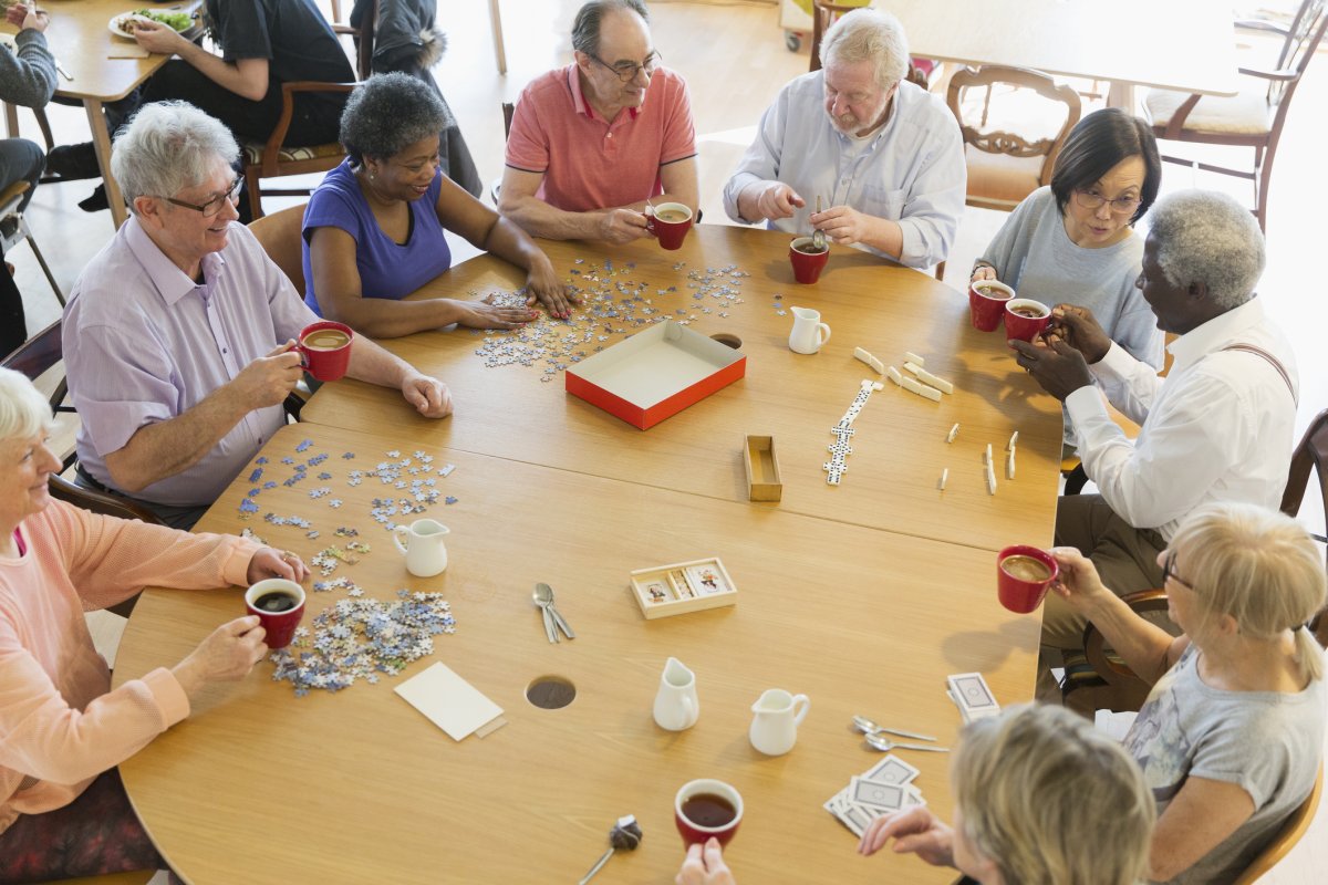Older people playing games round a table