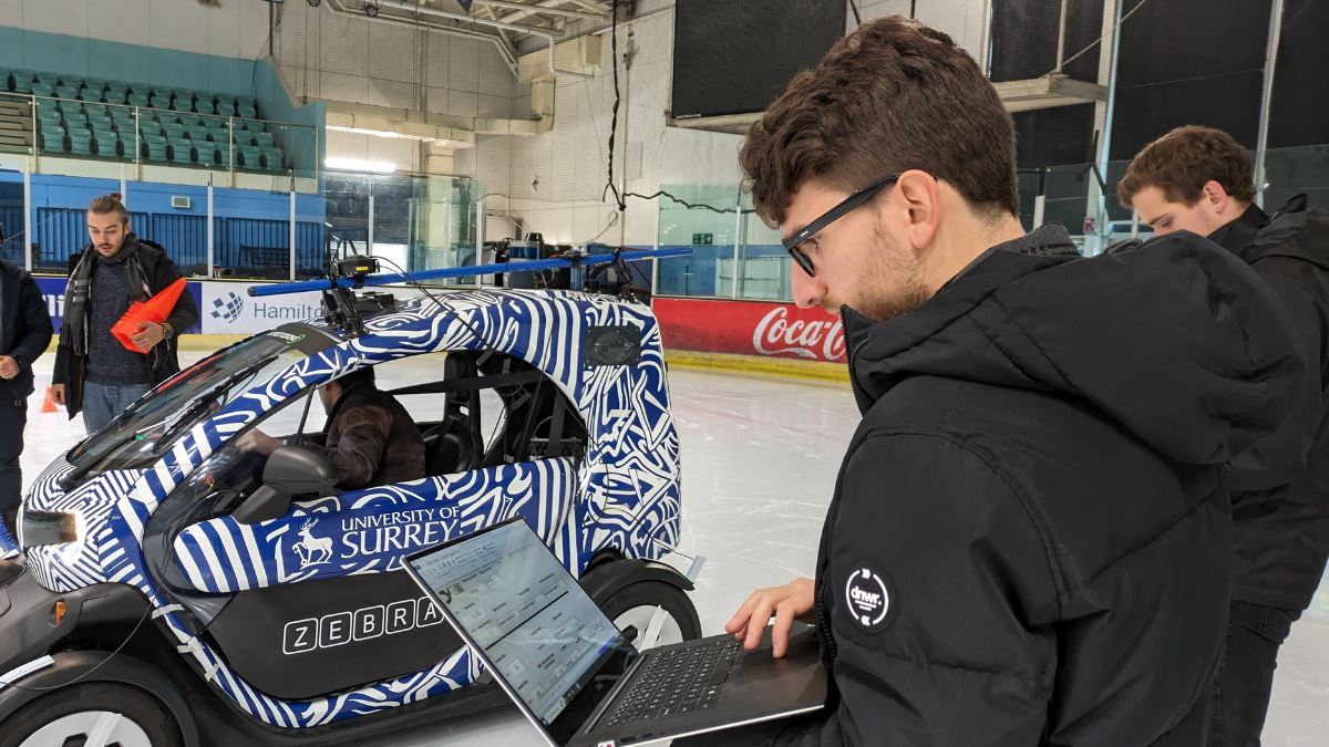 Carmine Caponio checks the data beside the autonomous vehicle on the ice rink