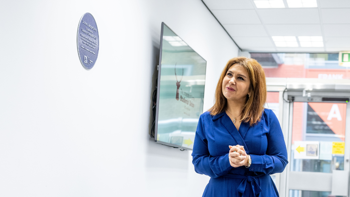 Dr Anna Vartapetiance admires her purple plaque in the Faculty of Engineering and Physical Sciences