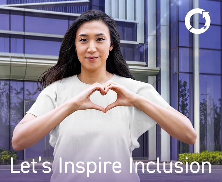 International Women's Day image with person in a white T-shirt using their hands in the shape of a heart. Text reads "Let's Inspire Inclusion"