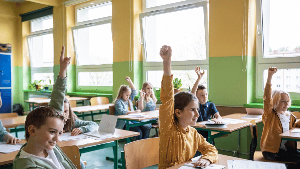 children in a classroom with open windows