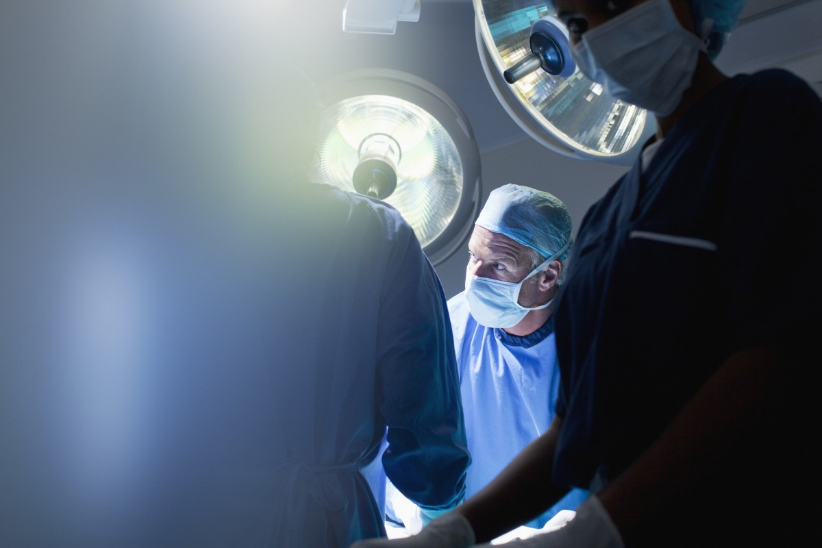 Man performs surgery in theatre