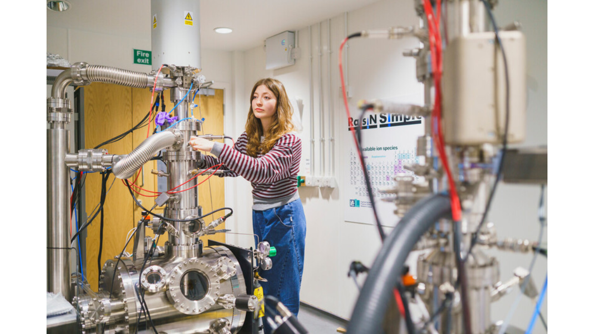 A photograph of Dr Ella Schneider in Surrey's Ion Beam Centre