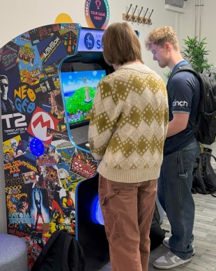 Two University of Surrey students playing on games arcade machine