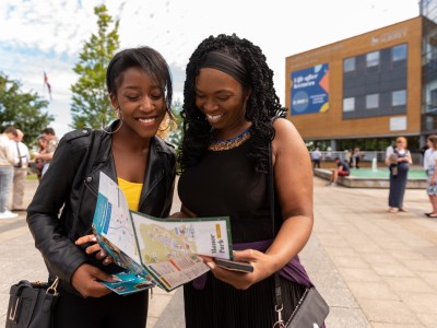students looking at open day map outside campus buildings