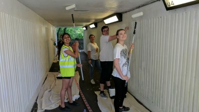 University of Surrey staff painting an underpass in Park Barn, Guildford