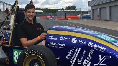 Male student in formula one car