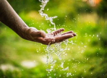 hands under stream of running water