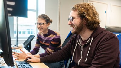 Two students sitting in front of a computer