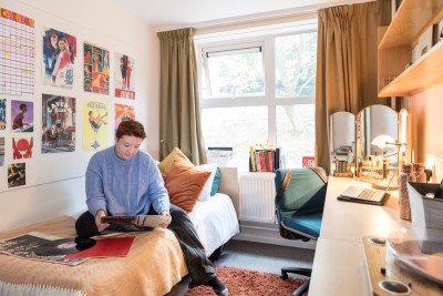 A student relaxing in our on-campus accommodation