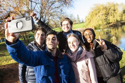 a group of students taking a selfie on campus