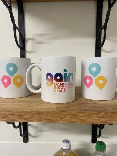 GAIN mugs on shelf