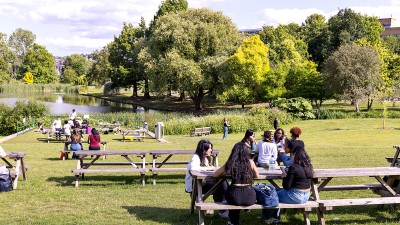 Students sitting by the lake