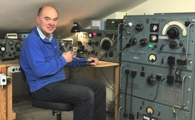 Professor Sir Martin Sweeting sat with radio equipment