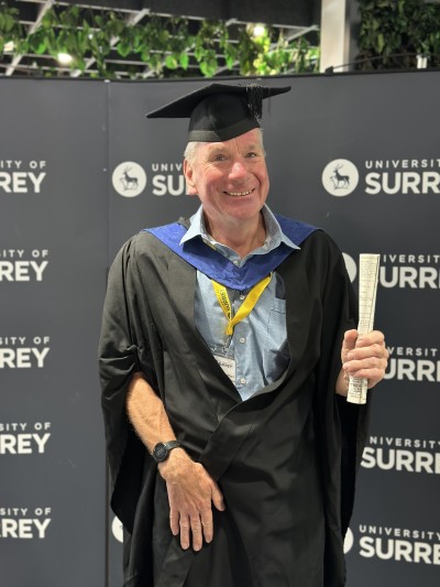 A photo of Steve in a graduation gown.
