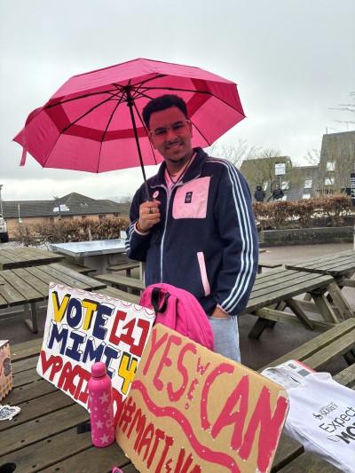 University of Surrey Public Affairs MSc student, Matt, underneath an umbrella