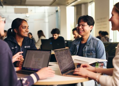 Students studying and smiling in library