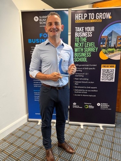 Delegate holding an award at Surrey Business School Celebrating Partners event on 24 June 2026