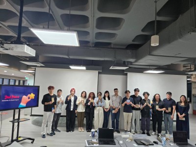 A group of people stand by a screen that says 2nd Place.