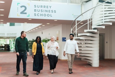 Surrey Business School foyer at the University of Surrey with students walking through