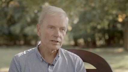 Chris Dewdney sat on a bench outside