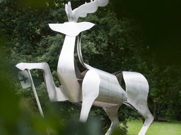 The university stag statue with leaves in the foreground