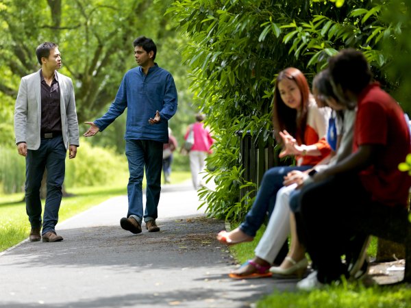 Students sitting by the lake having a discussion