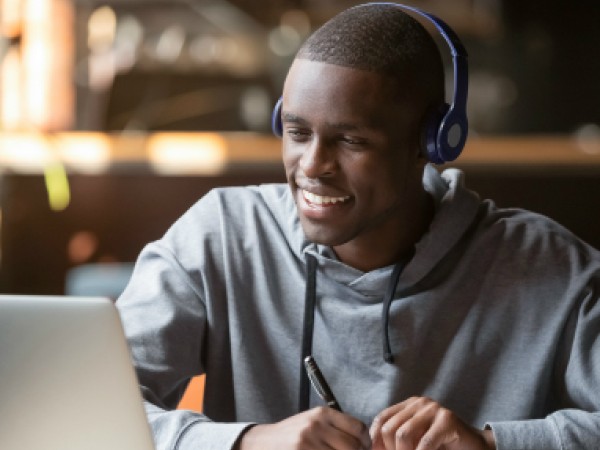 male student looking at his laptop screen