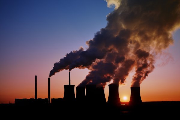 Power station with large amounts of smoke pouring from the top