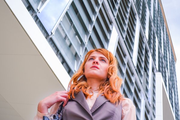 student in front of building