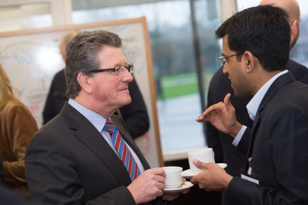Two men talking over coffee