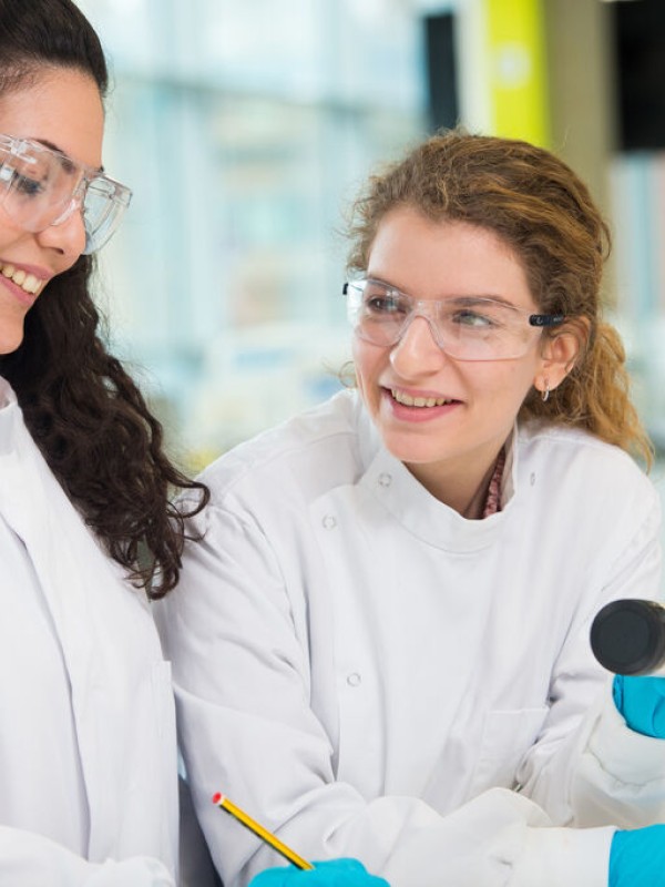 Two female researchers in biochemistry laboratory