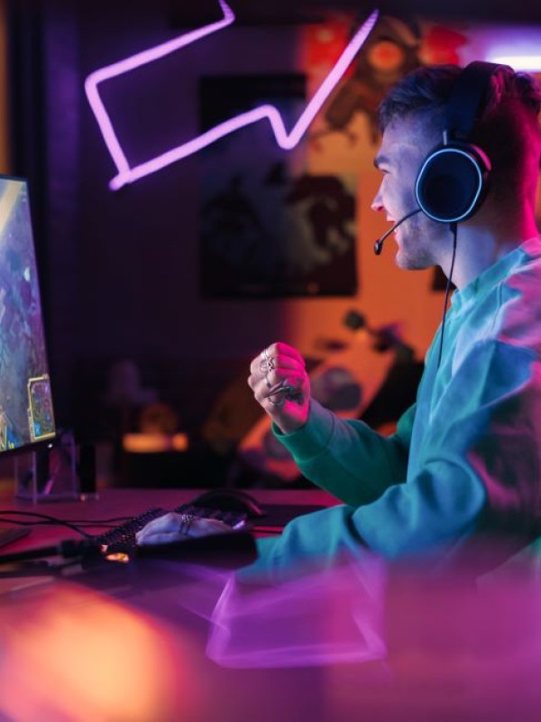 Male sitting in front of computer screen playing a video game